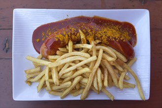 Currywurst with French fries served in a Franconian beer garden