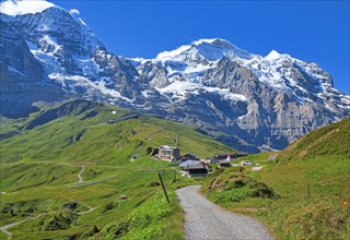 Hiking trail on Kleine Scheidegg in front of Moench and Jungfrau massif