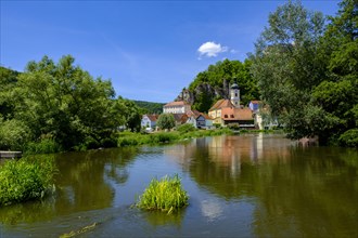 Village view with church on the river Naab