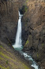 Waterfall Litlanesfoss between columnar basalt