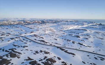 Lonely road to the North Cape in snow covered arctic landscape by car