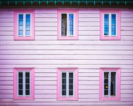 Pink wooden facade with windows