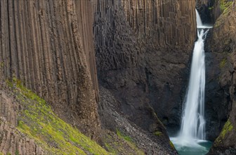 Waterfall Litlanesfoss between columnar basalt