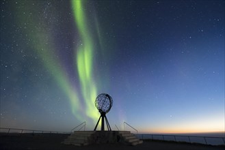 Steel globe at North Cape with northern lights