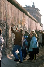 Tourists called wall woodpeckers at the Berlin Wall and Brandenburg Gate