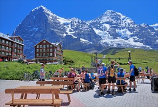 Tourists and hikers on Kleine Scheidegg in front of the Eiger and Moench