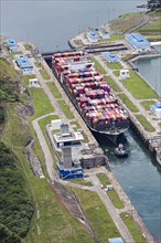 Aerial view of Neo-Panamax container ship crossing the third set of locks at the pacific side