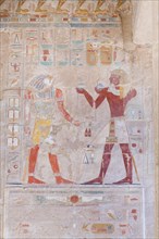Bas relief picture depicting the pharaoh (on the right) making offerings to the God Horus
