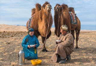 Shepherds with their camels at lunch