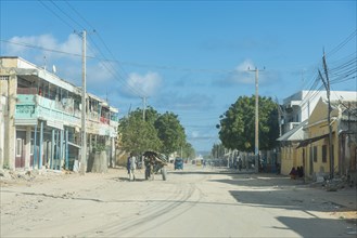 Somali woman before the destroyed houses of Mogadishu