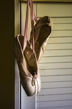 Ballet shoes hanging on the wall