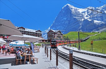 Kleine Scheidegg with restaurant terrace and Jungfrau Railway in front of the Eiger