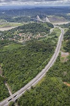 The Pan-American highway through the rainforest with bridge over the Panama Canal