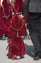 Child in penitential attire in the procession for Holy Week in Baeza