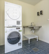 Washroom with large washing machine and dryer