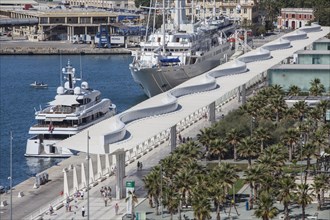 Luxury yachts and Palmeral De Las Sorpresas in the port of Malaga