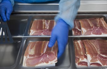 Cured ham being packaged