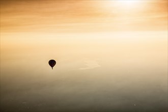 Hot air balloon rides towards sunset