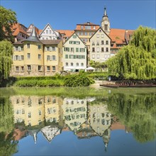 Tuebingen's old town with Hoelderlin Tower and Collegiate Church reflected in the Neckar River