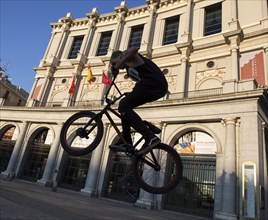 Youngster with BMX in front of the Real Theater