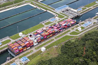 Aerial view of Neo-Panamax container ship crossing the third set of locks at the pacific side