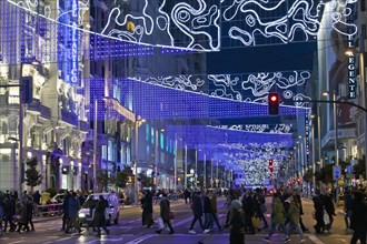 Pedestrians in La Gran Via with Christmas lights