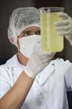 Employee measures rosemary oil at the cosmetics factory in Itupeva