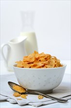 Cornflakes in bowl with spoon