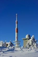 Transmitter mast and Brocken hostel on the winter snow-covered Brocken