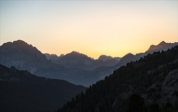 Sunrise in front of mountain silhouette