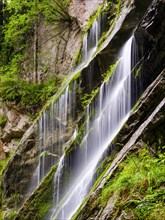 Waterfall on mossy rock face