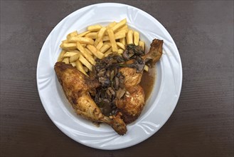 Two chicken legs with mushroom spring onions