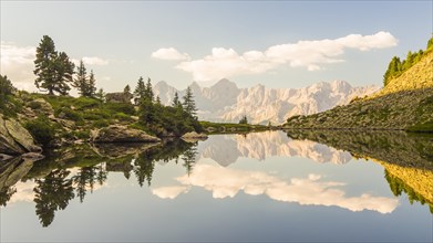 The Hoher Dachstein is reflected in the lake of mirrors at last daylight