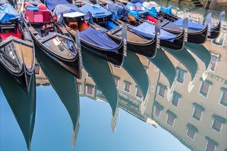 Venetian gondolas reflected in the water