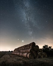 Perseids shooting star over field after harvest