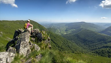 Hiker overlooking Cantal mountains