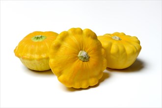 Three yellow patisson pumpkins