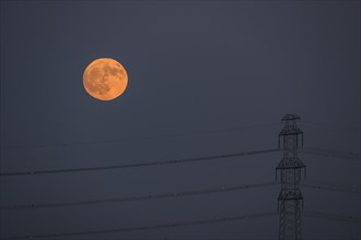 Power pole with full moon