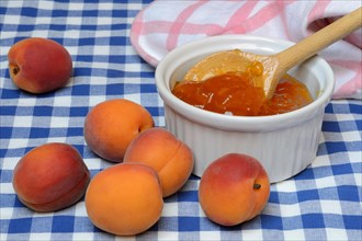 Apricot jam in small bowls and apricots