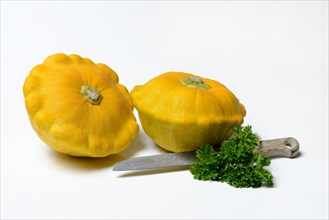 Yellow patisson pumpkins with parsley and kitchen knife