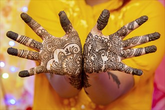 Hand of a bride painted with henna on the eve of the wedding