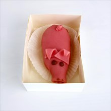 Marzipan pig in a box of pastry