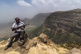 Sentry with rifle in the mountains