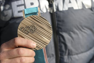 Bronze medal in the hands of an athlete