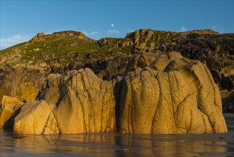 Moon above the rocky coast at Porth Nanven