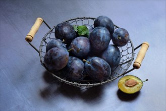 Plums in wire basket