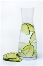 Cucumber slices in carafe with water