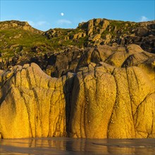 Moon above the rocky coast at Porth Nanven