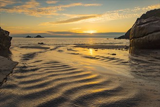 Sunset on the rocky coast at Porth Nanven