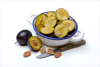 Halved plums in bowl